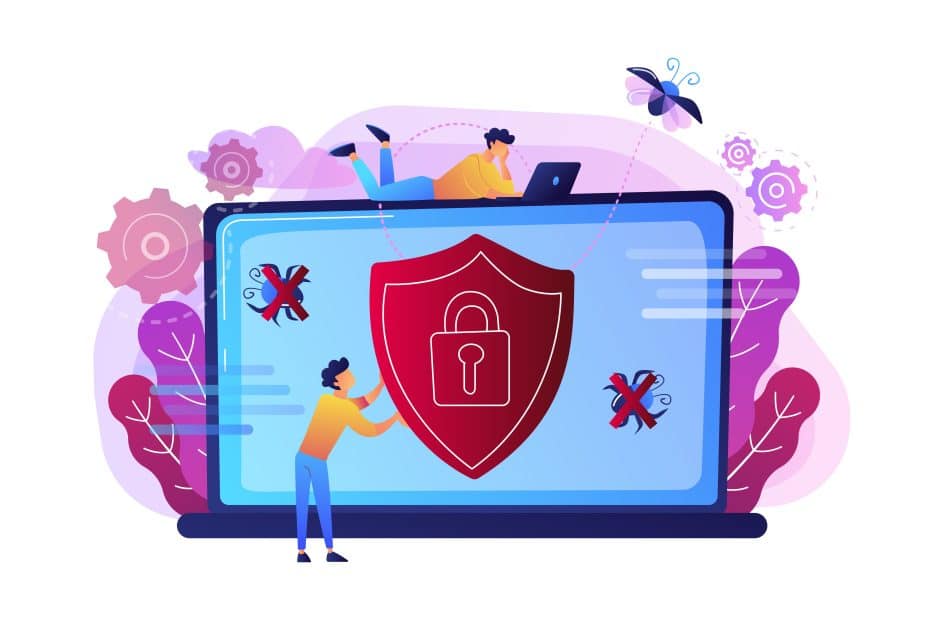 Des personnes travaillent sur un ordinateur portable avec un bouclier affiché à l'écran, symbolisant la cybersécurité.